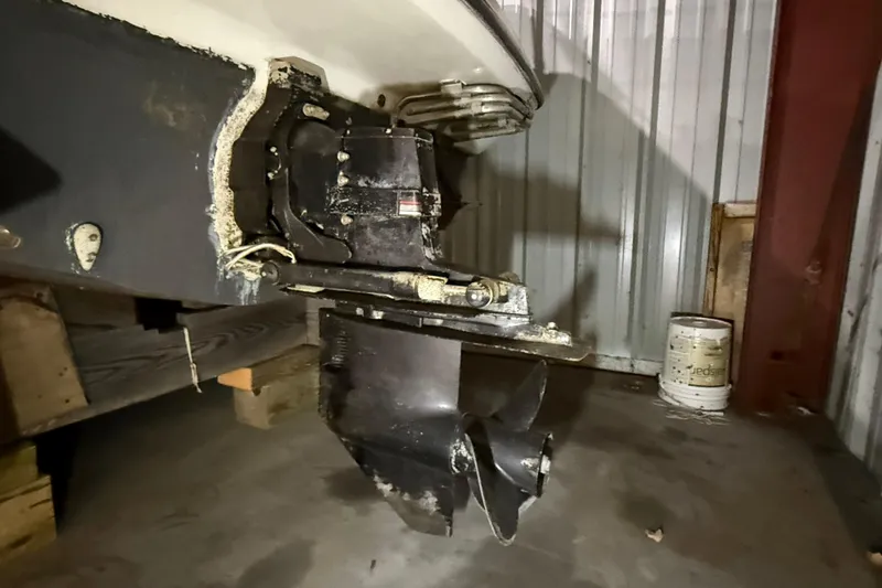Slide: The Image of 1995 Carver 250 Express boat propeller and stern drive in storage. - 24