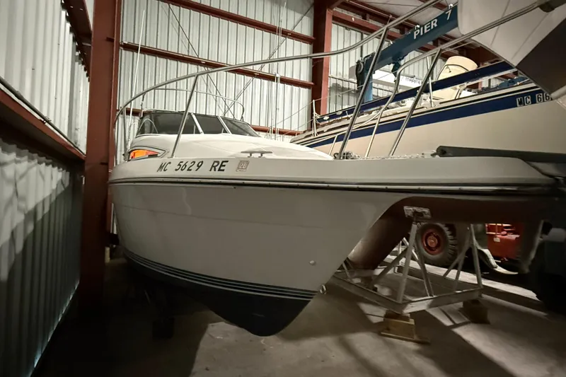 Slide: The Image of 1995 Carver 250 Express boat stored indoors, side view. - 26