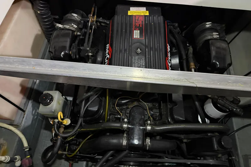 Slide: The Image of Engine compartment of a 1995 Carver 250 Express boat, featuring a MerCruiser engine. - 28