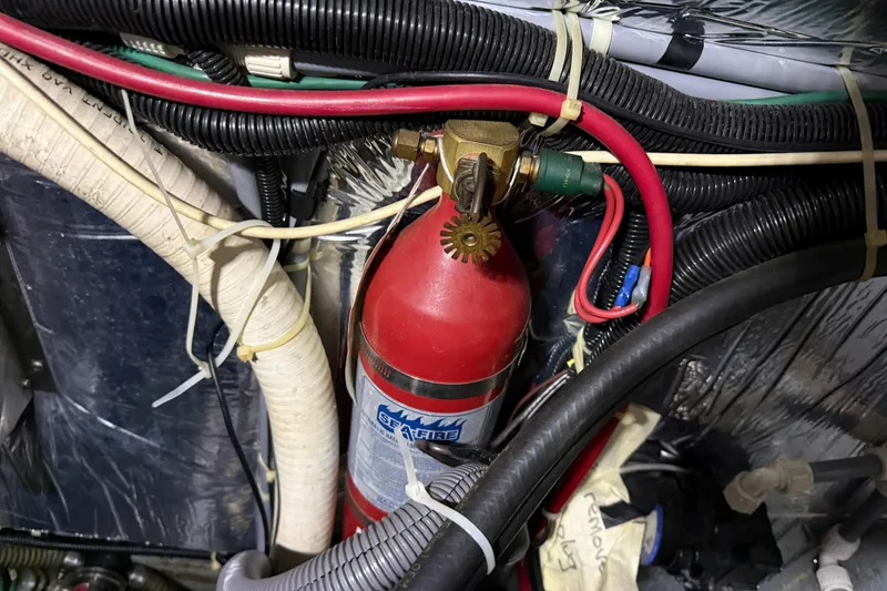 Slide: The Image of Engine compartment of 1995 Carver 250 Express with fire extinguisher and wiring. - 32