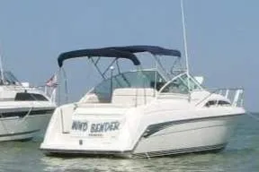 Slide: The Image of 1995 Carver 250 Express boat on water with canopy and sleek design. - 33