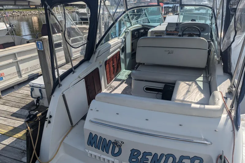 Slide: The Image of 1995 Carver 250 Express boat named "Mind Bender" docked at a marina. - 4