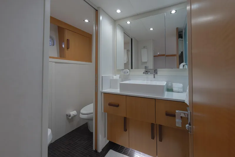 Slide: The Image of Luxurious bathroom in 2012 Lazzara Breeze yacht with modern fixtures and wooden cabinetry. - 19
