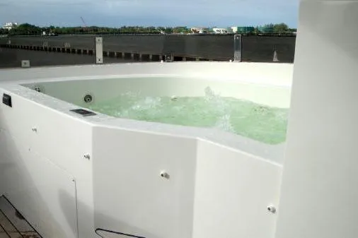 Slide: The Image of Luxurious hot tub on 2012 Lazzara Breeze yacht deck, with bubbling water and scenic view. - 38