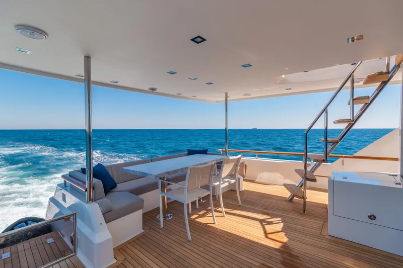 Slide: The Image of Luxurious 2012 Lazzara Breeze yacht deck with ocean view, featuring seating and dining area. - 43
