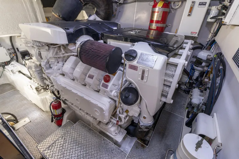 Slide: The Image of Engine room of 2012 Lazzara Breeze yacht with visible machinery and fire extinguisher. - 49