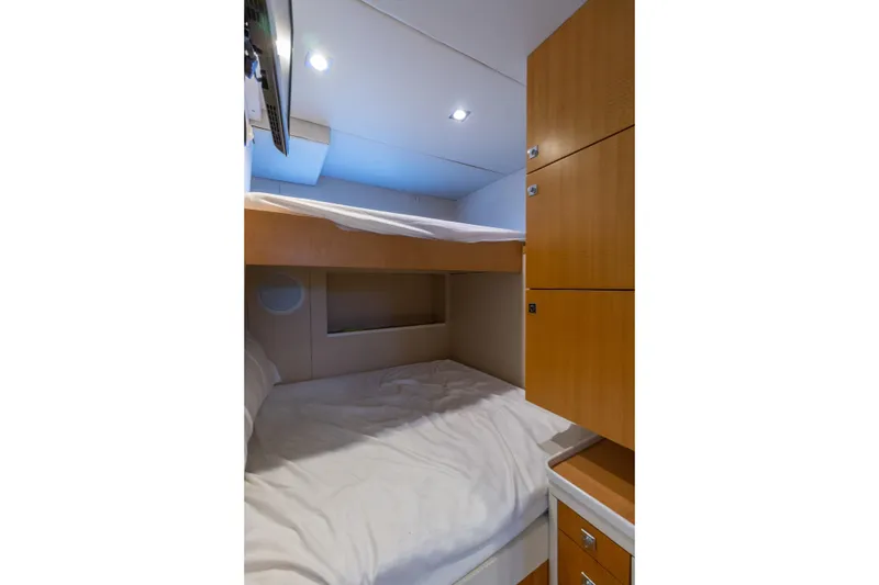 Slide: The Image of 2012 Lazzara Breeze yacht cabin with bunk beds and wooden cabinetry. - 52