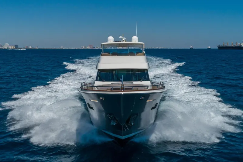 Slide: The Image of 2012 Lazzara Breeze yacht cruising on open blue sea, creating a dynamic wake. - 57