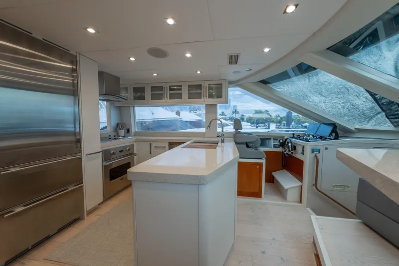 Slide: The Image of Luxurious 2012 Lazzara Breeze yacht interior with modern kitchen and helm station. - 7