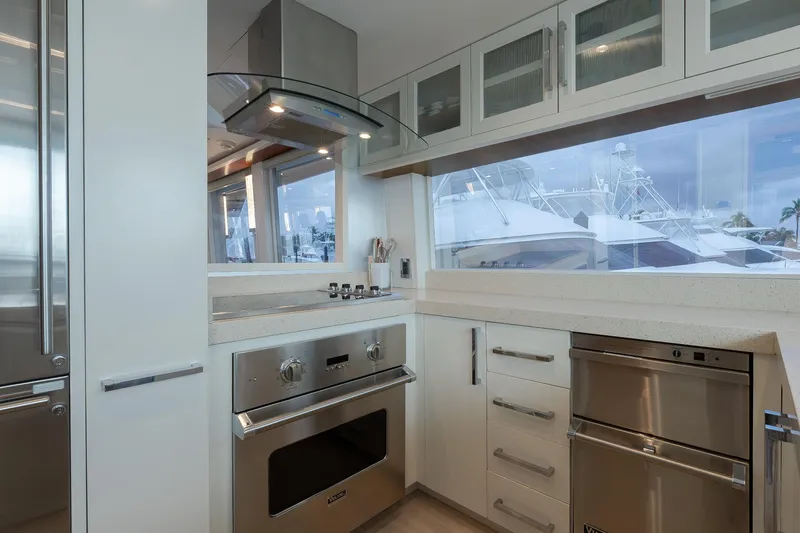 Slide: The Image of Modern kitchen interior on 2012 Lazzara Breeze yacht, featuring sleek appliances and large windows. - 8