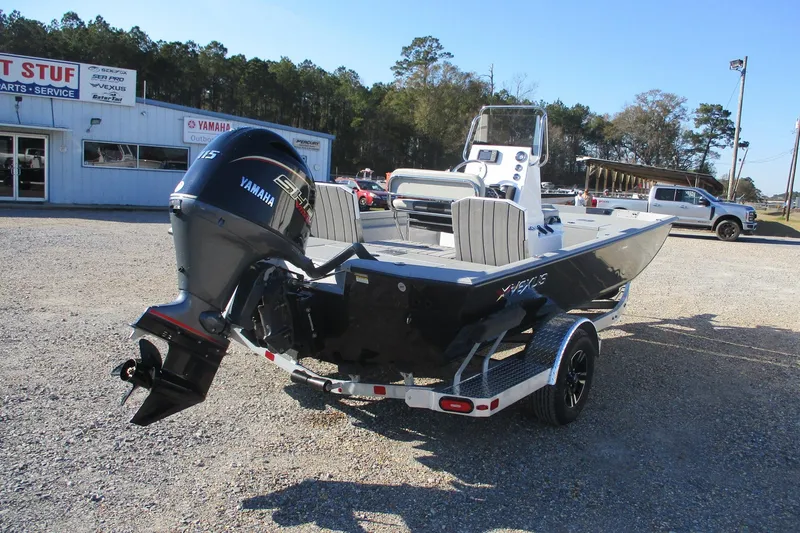 Slide: The Image of 2026 Vexus Defender 201 boat with Yamaha engine, parked outdoors near dealership. - 2