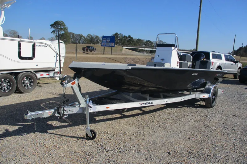 Slide: The Image of 2026 Vexus Defender 201 boat on trailer, parked outdoors on gravel. - 6