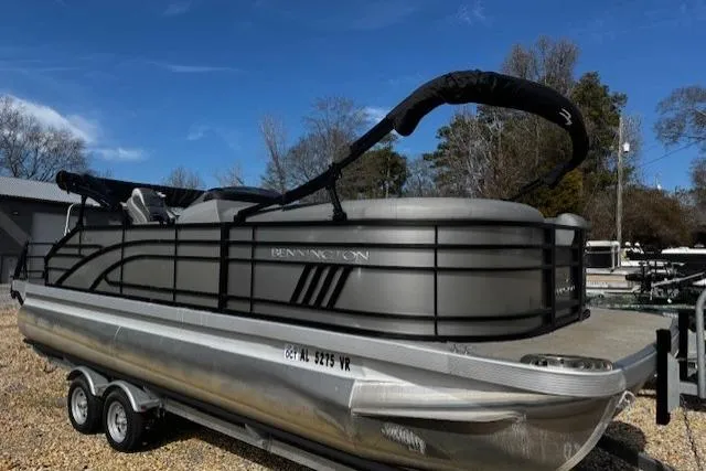 The Image of 2022 Bennington 23 LSB pontoon boat on trailer, parked outdoors. - 0
