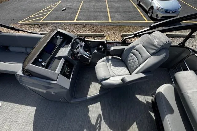 Slide: The Image of 2022 Bennington 23 LSB boat interior with steering console and plush seating. - 10