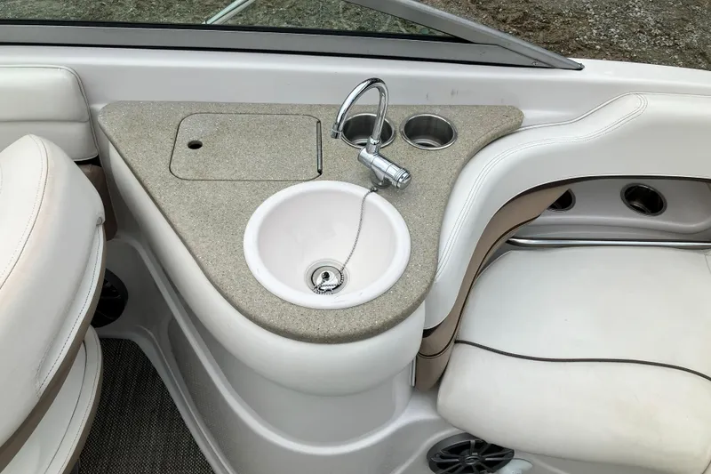 Slide: The Image of 2006 Four Winns 240 Horizon boat interior with sink and seating area. - 12