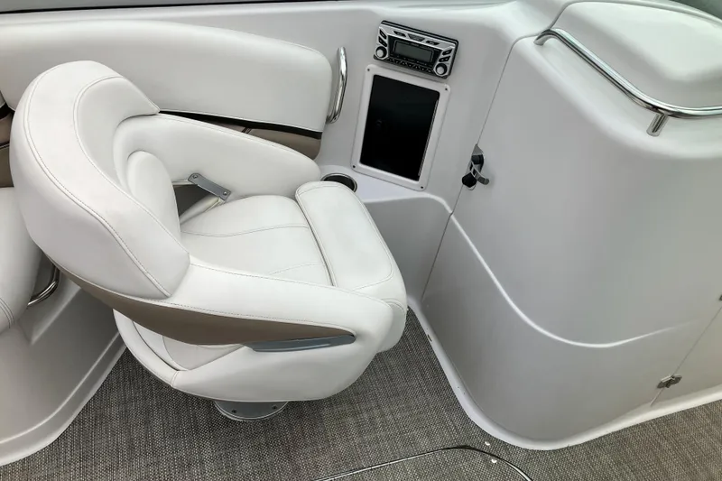 Slide: The Image of 2006 Four Winns 240 Horizon boat interior with white captain's chair and control panel. - 14