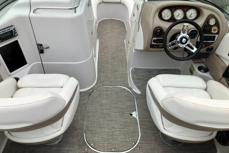 Slide: The Image of 2006 Four Winns 240 Horizon boat interior with white seats and modern dashboard. - 15