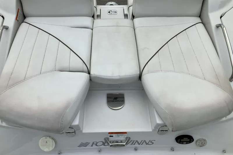 Slide: The Image of 2006 Four Winns 240 Horizon boat seating area with white upholstery and logo. - 17