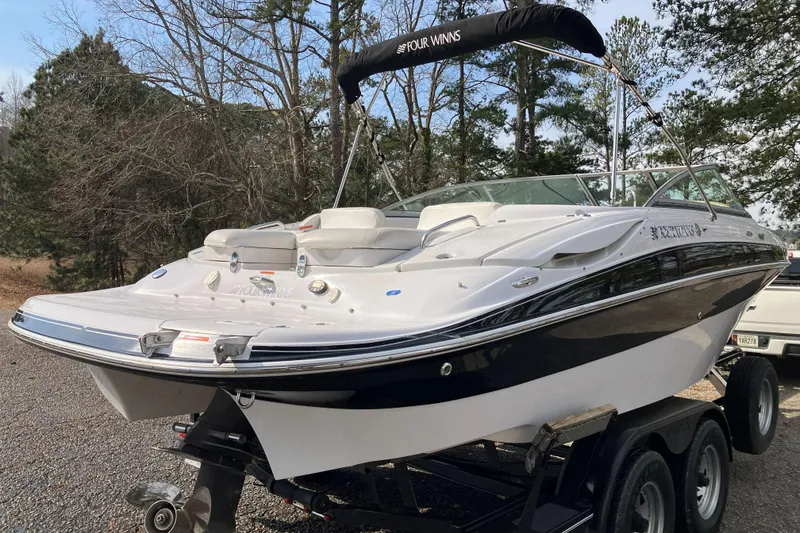 Slide: The Image of 2006 Four Winns 240 Horizon boat on trailer, surrounded by trees. - 5