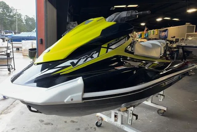 The Image of 2019 Yamaha WaveRunner VX Deluxe in a showroom, featuring a sleek black and yellow design. - 1