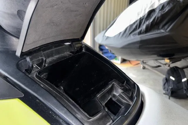 Slide: The Image of Open storage compartment of a 2019 Yamaha WaveRunner VX Deluxe in a garage setting. - 12