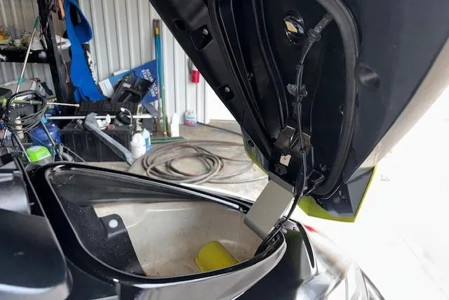 Slide: The Image of 2019 Yamaha WaveRunner VX Deluxe with open storage compartment in a garage setting. - 13