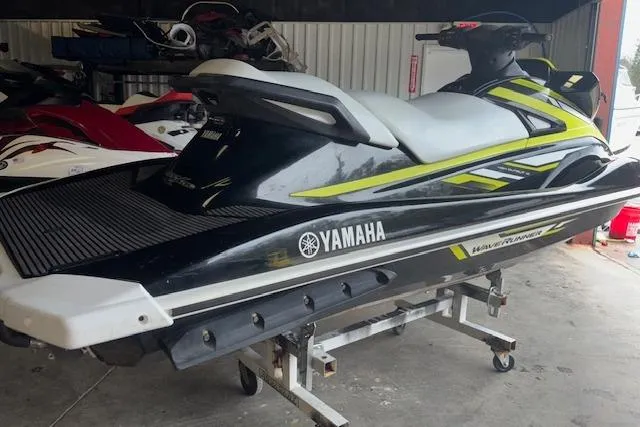 Slide: The Image of 2019 Yamaha WaveRunner VX Deluxe jet ski in storage, black and yellow design. - 7