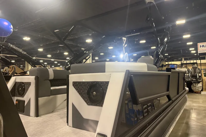 Slide: The Image of Interior of 2026 Alera M25Q boat with modern seating and speaker system. - 10