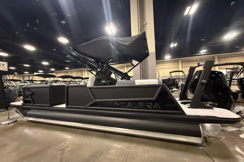 Slide: The Image of 2026 Alera M25Q boat interior at a showroom, featuring modern seating and design. - 2
