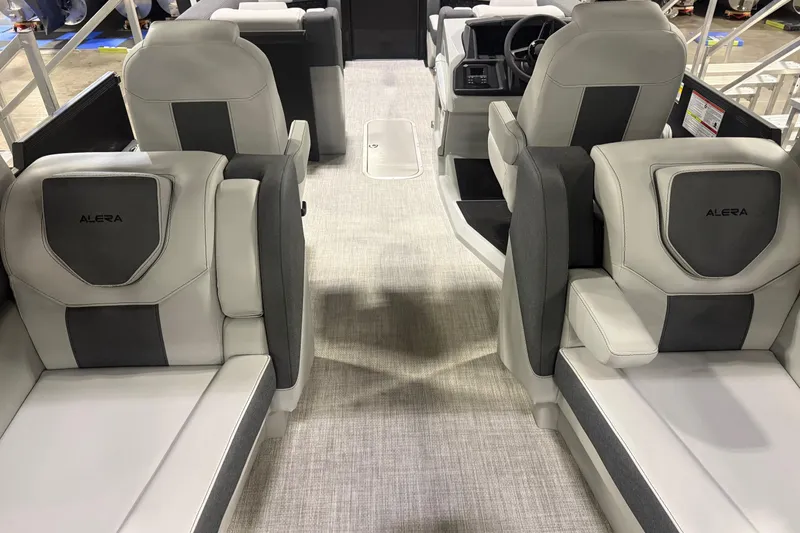 Slide: The Image of Captain's seat and steering console of 2026 Alera M25Q boat, featuring modern design and controls. - 7