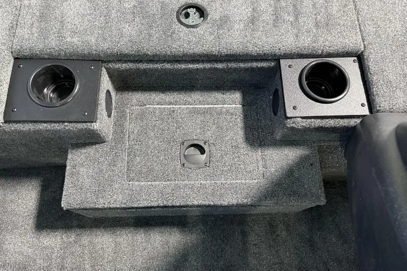 Slide: The Image of 2026 Tracker Pro Team 175 boat interior with carpeted deck and cup holders. - 13