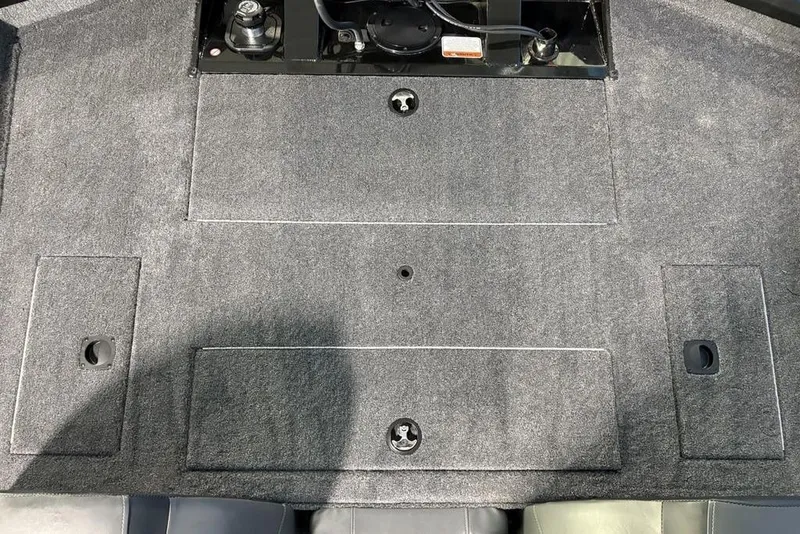 Slide: The Image of 2026 Tracker Pro Team 175 boat deck with storage compartments and carpeted surface. - 19