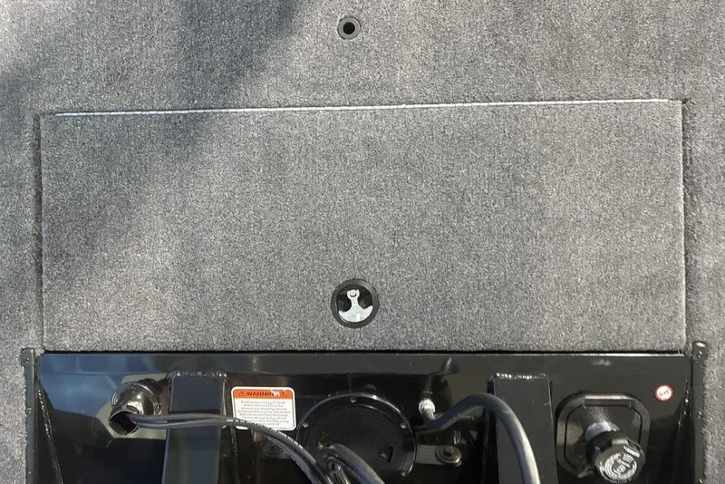 Slide: The Image of 2026 Tracker Pro Team 175 boat interior with carpeted surface and control panel. - 22