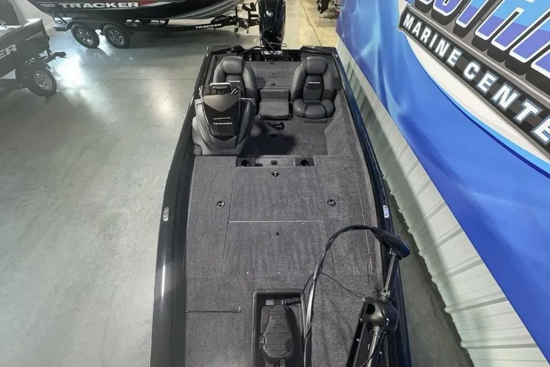 Slide: The Image of 2026 Tracker Pro Team 175 boat interior at a marine center showroom. - 29