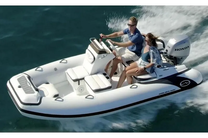 The Image of Manufacturer Provided Image: 2025 Walker Bay Generation 13 LTE boat cruising on water with two passengers. - 1