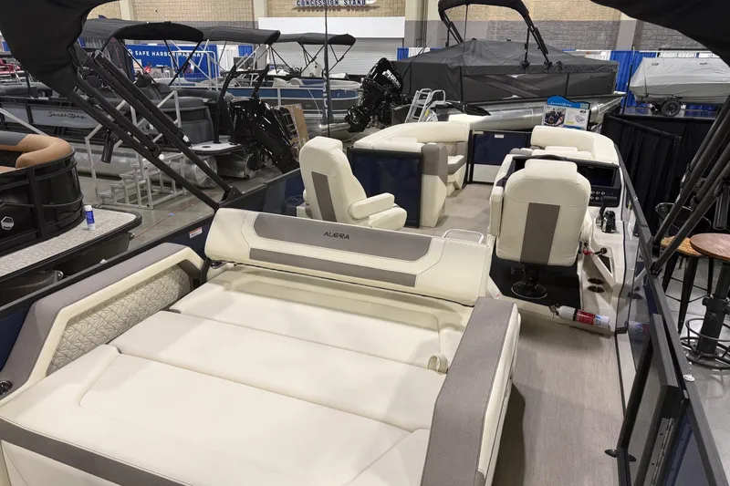 Slide: The Image of 2026 Alera M23L luxury boat interior with plush seating at a boat show. - 3