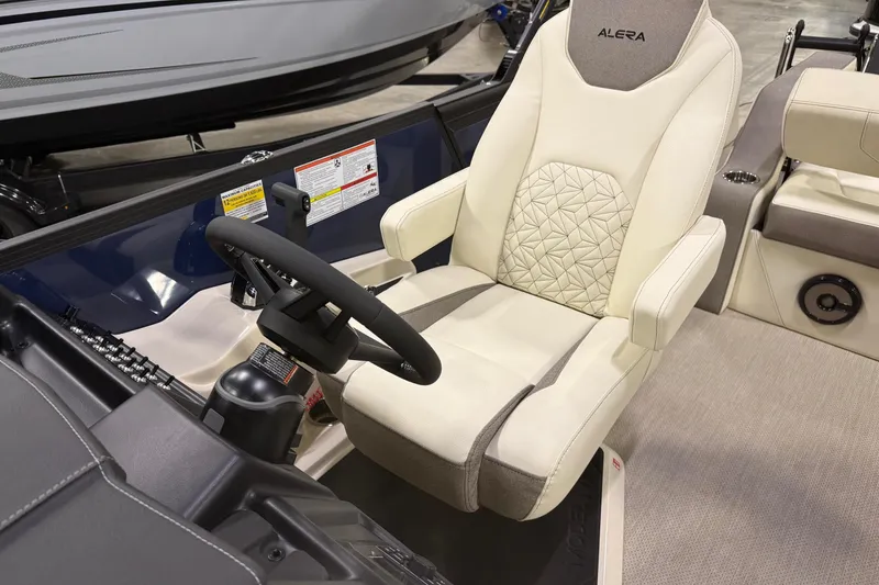 Slide: The Image of Captain's seat of 2026 Alera M23L boat with steering wheel and controls. - 7