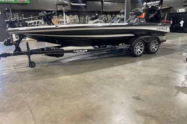 The Image of 2026 Caymas CX 20 boat on trailer in showroom, black and white design. - 0
