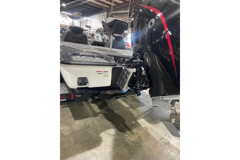 Slide: The Image of 2026 Caymas CX 20 boat with powerful outboard motor in showroom setting. - 11