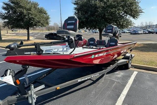 Slide: The Image of 2020 Ranger RT178 boat in parking lot, red color, on trailer, with Minn Kota motor. - 2