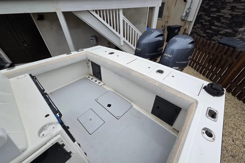 Slide: The Image of 1996 Regulator 26 Classic boat with dual Yamaha 200 engines, parked outdoors. - 10