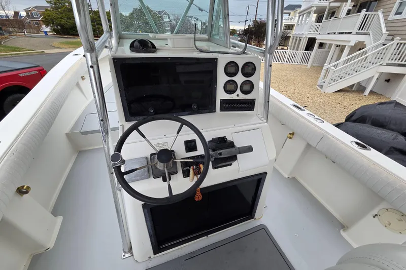 Slide: The Image of 1996 Regulator 26 Classic boat cockpit with steering wheel and instrument panel. - 11