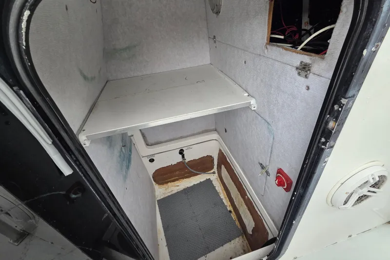 Slide: The Image of Interior of a 1996 Regulator 26 Classic boat showing storage compartment. - 16