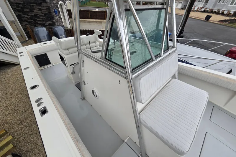 Slide: The Image of 1996 Regulator 26 Classic boat interior with seating and dual outboard motors. - 20