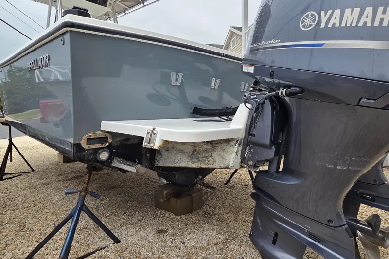 Slide: The Image of 1996 Regulator 26 Classic boat with Yamaha outboard motor on stands. - 6