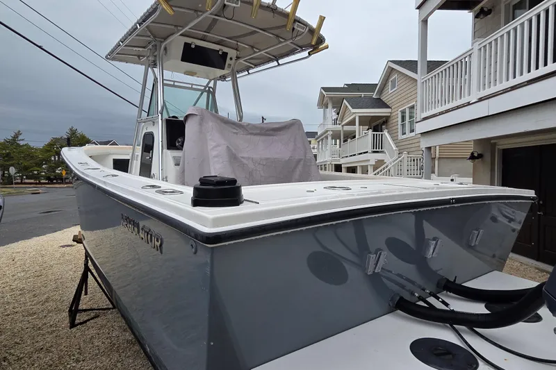 Slide: The Image of 1996 Regulator 26 Classic boat parked in residential area, showcasing sleek design and sturdy build. - 7