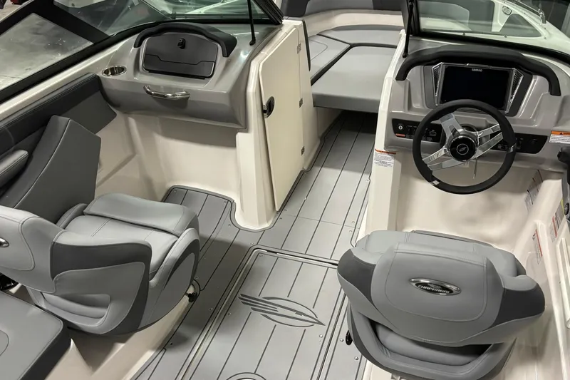 Slide: The Image of 2026 Chaparral 23 SSi boat interior with modern dashboard and comfortable seating. - 17