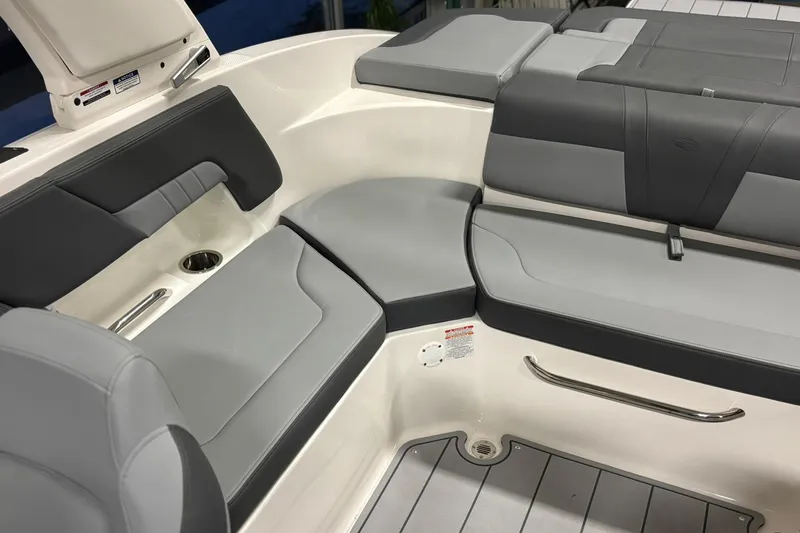 Slide: The Image of 2026 Chaparral 23 SSi boat interior with gray seating and cup holder. - 18