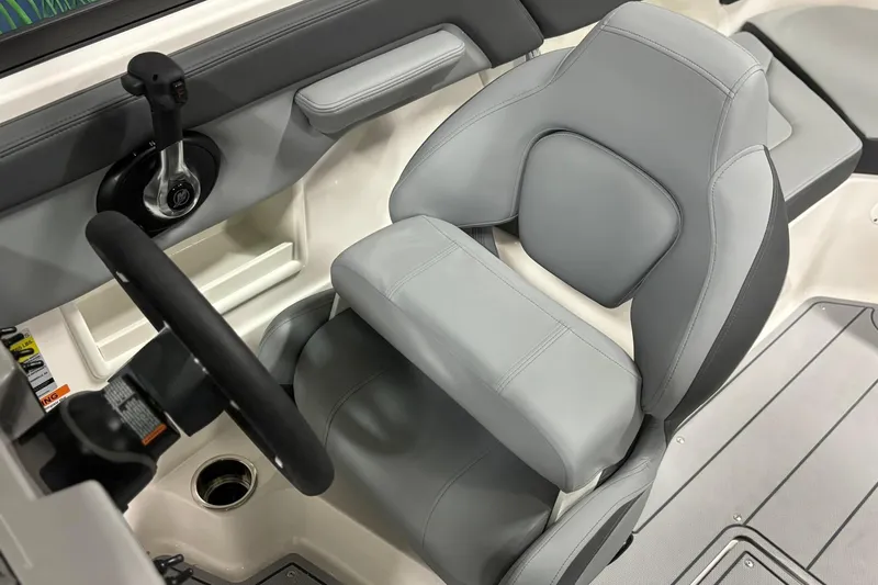 Slide: The Image of 2026 Chaparral 23 SSi boat interior with gray captain's seat and steering wheel. - 21