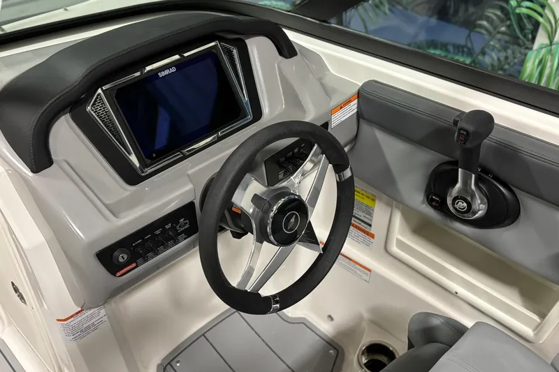 Slide: The Image of 2026 Chaparral 23 SSi boat dashboard with steering wheel and control panel. - 22